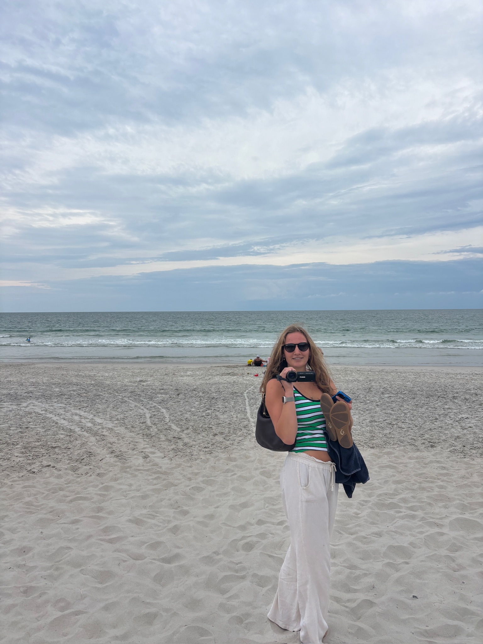Ella on the beach with camera